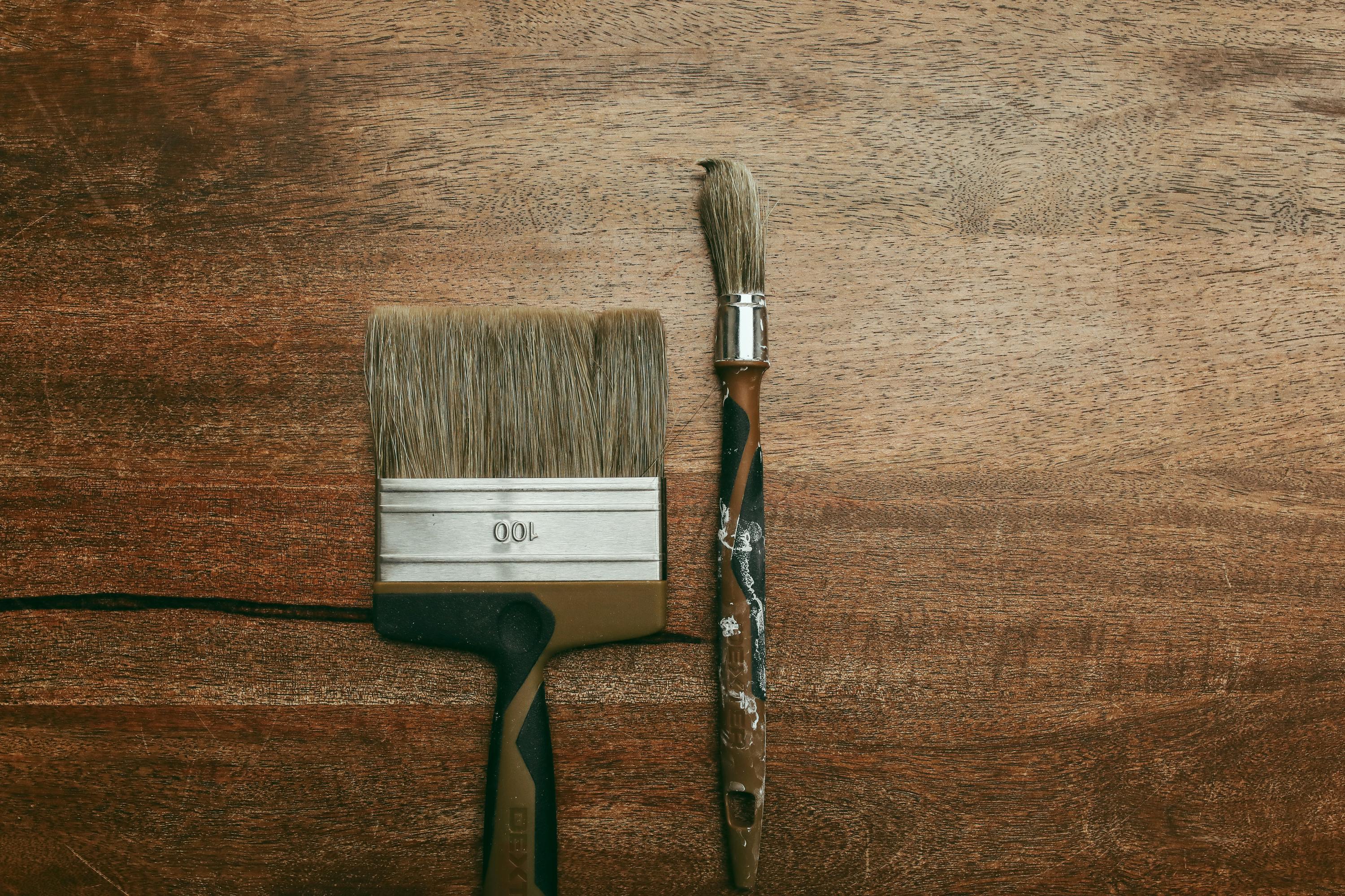 paintbrushes on a wood background